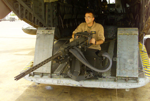 CAMP LEMONIER, Djibouti - Sgt. Richard A. Dorsett, HMH-461 aviation ordnanceman , demonstrates the operational abilities of the Ramp Mounted Weapon System (RMWS) here.  The RMWS provides CH-53 Super Stallion Helicopters with a much needed defensive system providing 180 degrees field of fire from the rear of the aircraft.   Photo by: Cpl. Eric C. Ely